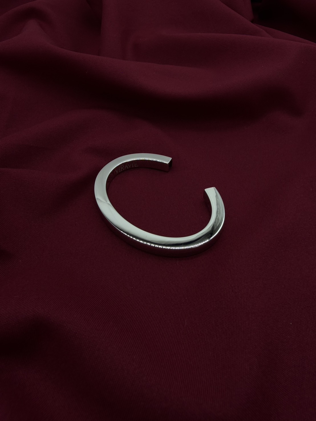 Silver VIRAVIE bracelet on burgundy fabric